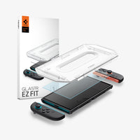 AGL10156 - Nintendo Switch 2 GLAS.tR EZ Fit in Clear showing the installation tray hovering above the film strip, screen protector and the device with the packaging on the side